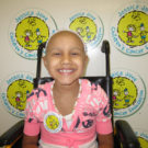 A smiling girl who is fighting cancer
