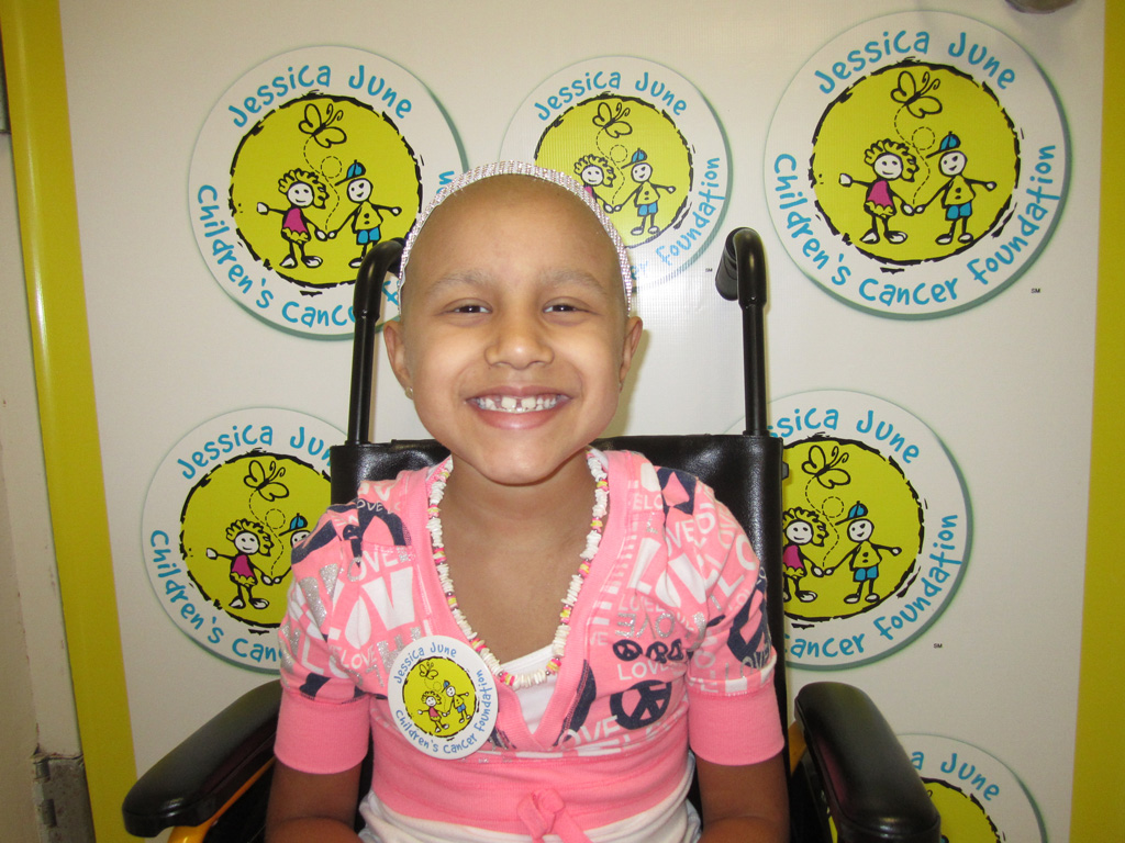 A smiling girl who is fighting cancer