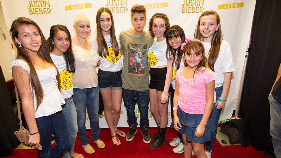 Justin Bieber taking a picture with girls